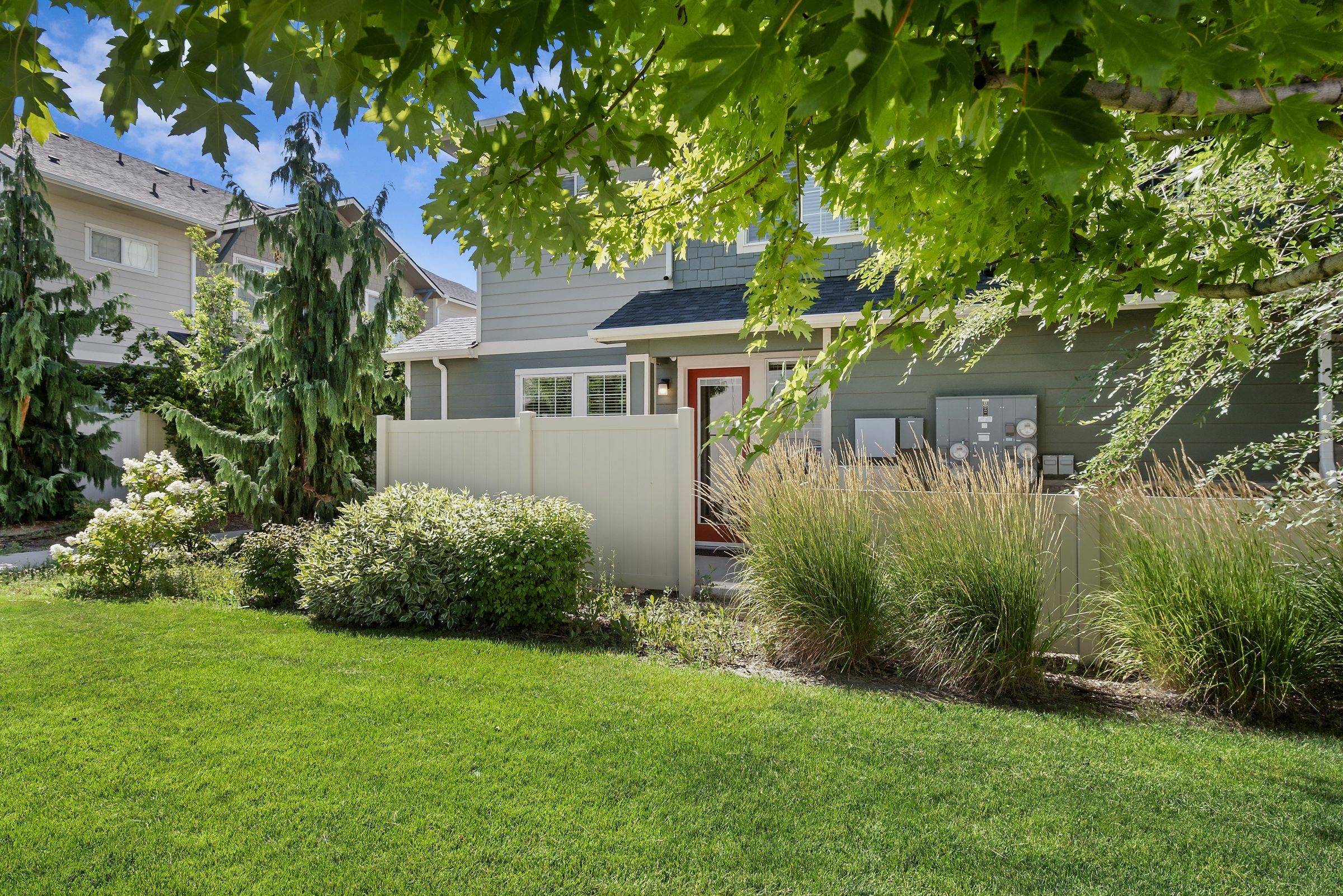 The Enclave townhome buildings with landscaped lawns and mature trees